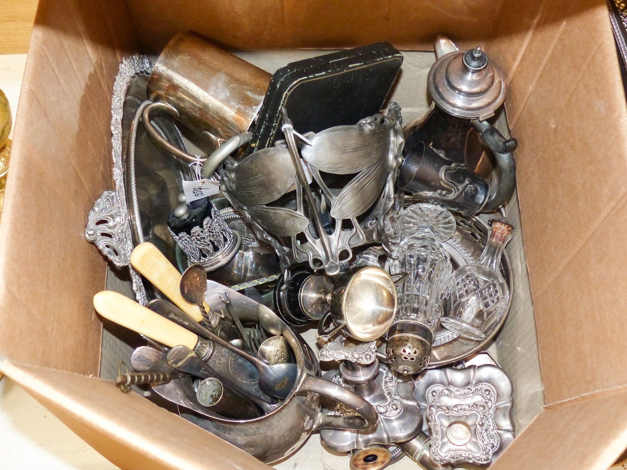 Sundry plated wares, including an oval galleried tea tray, a baluster coffee pot, sundry cutlery, a pair of dwarf candlesticks, a siphon stand, a salver, etc.